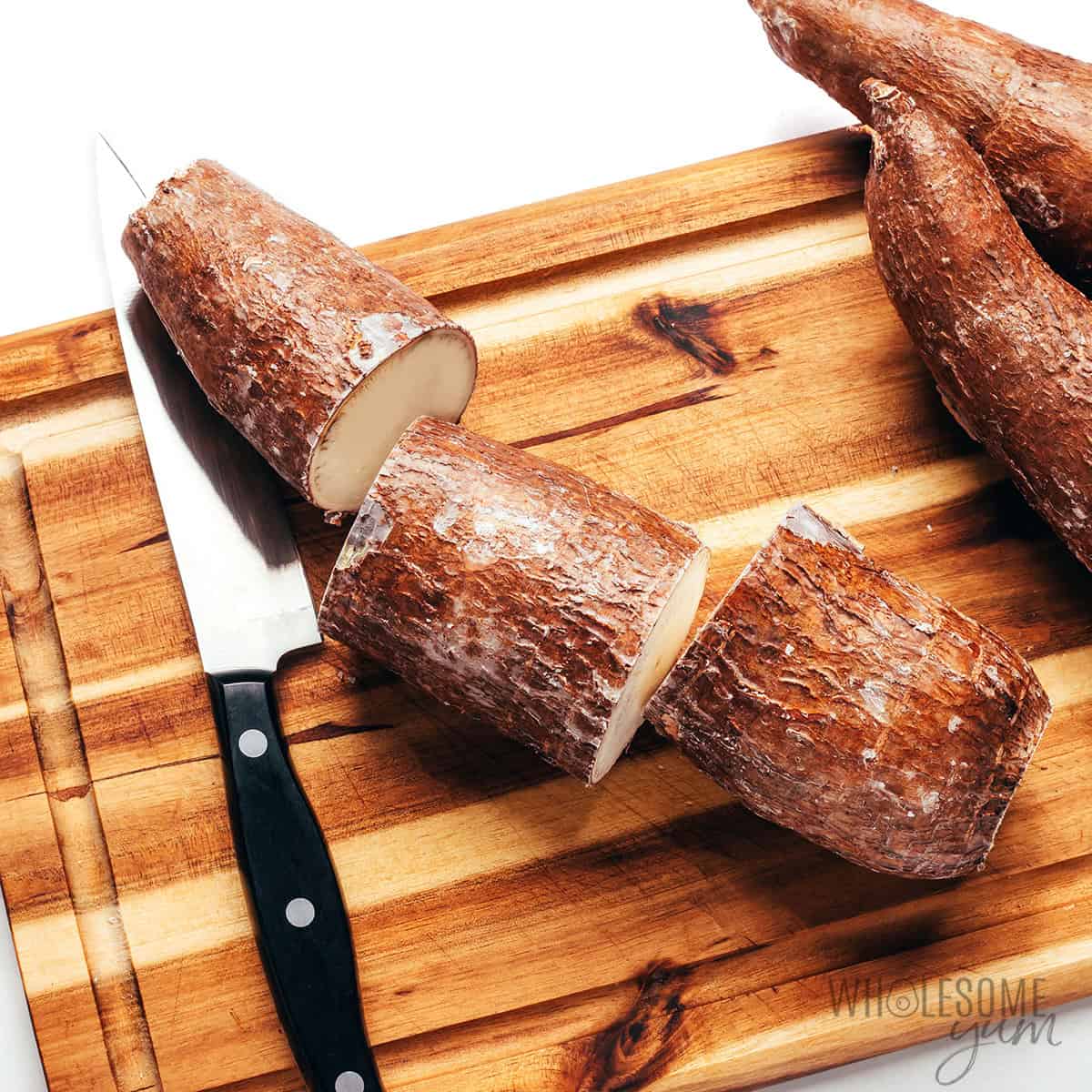 Cutting yuca root into short sections.