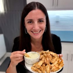 Maya dipping yuca fries into lime crema dip.