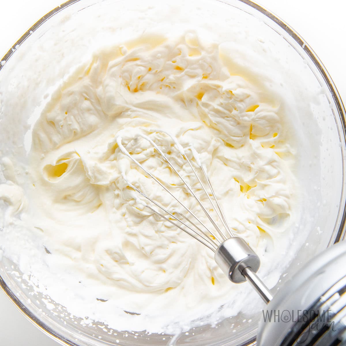 Beating heavy cream in a bowl.