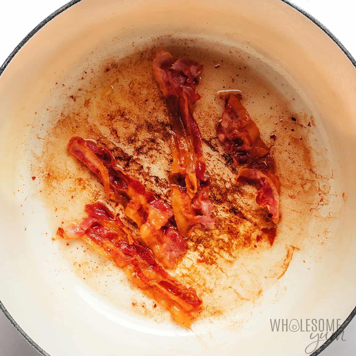 Cooking bacon in a Dutch oven.