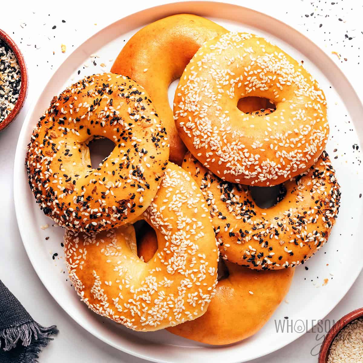 Freshly baked high protein bagels piled on a plate.