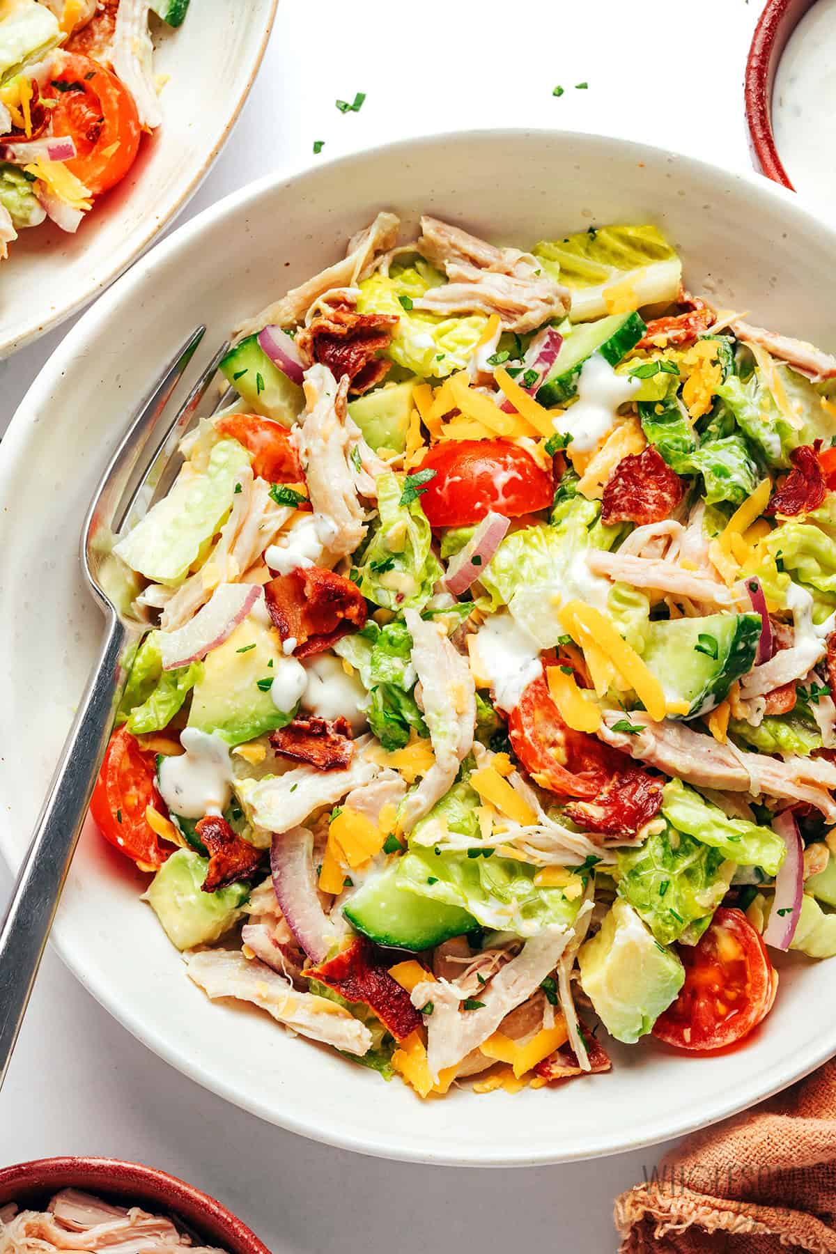 Fresh, crunchy, and creamy chicken bacon ranch salad in a bowl.