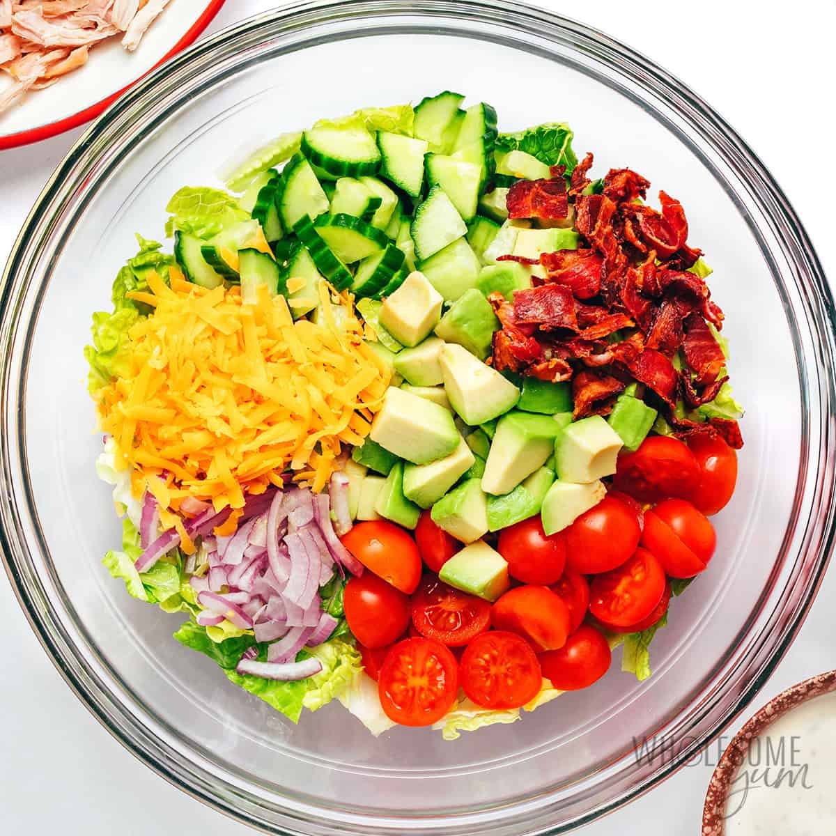 Veggies and bacon combined in a bowl.