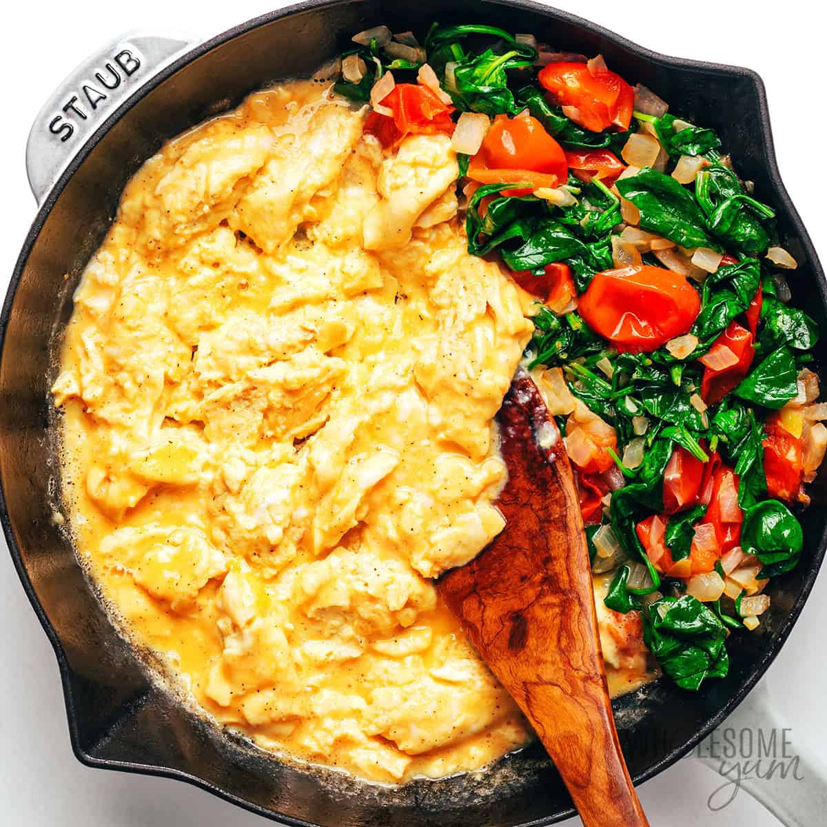 Scrambled eggs cooked next to the veggies.