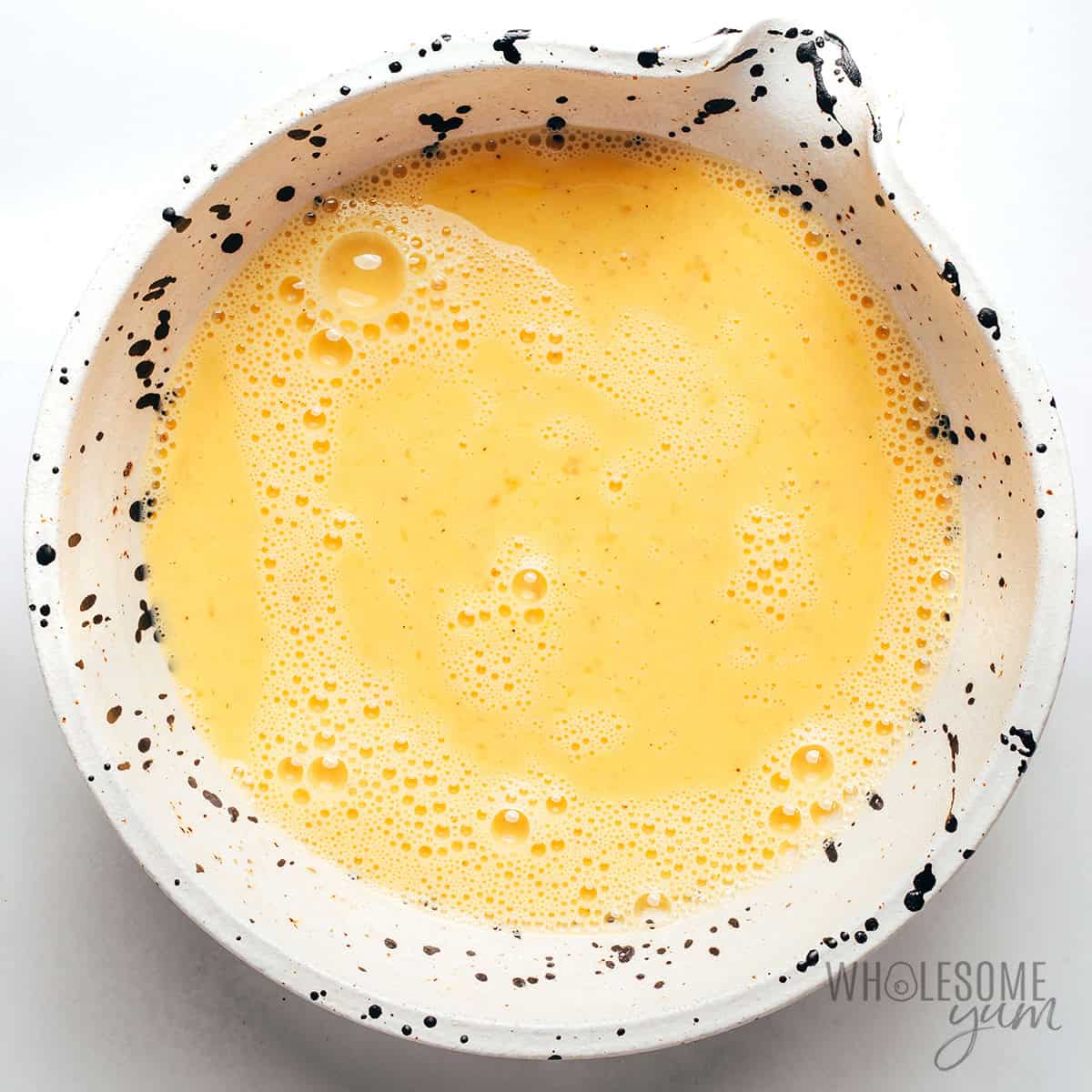 Whisked eggs in a bowl.