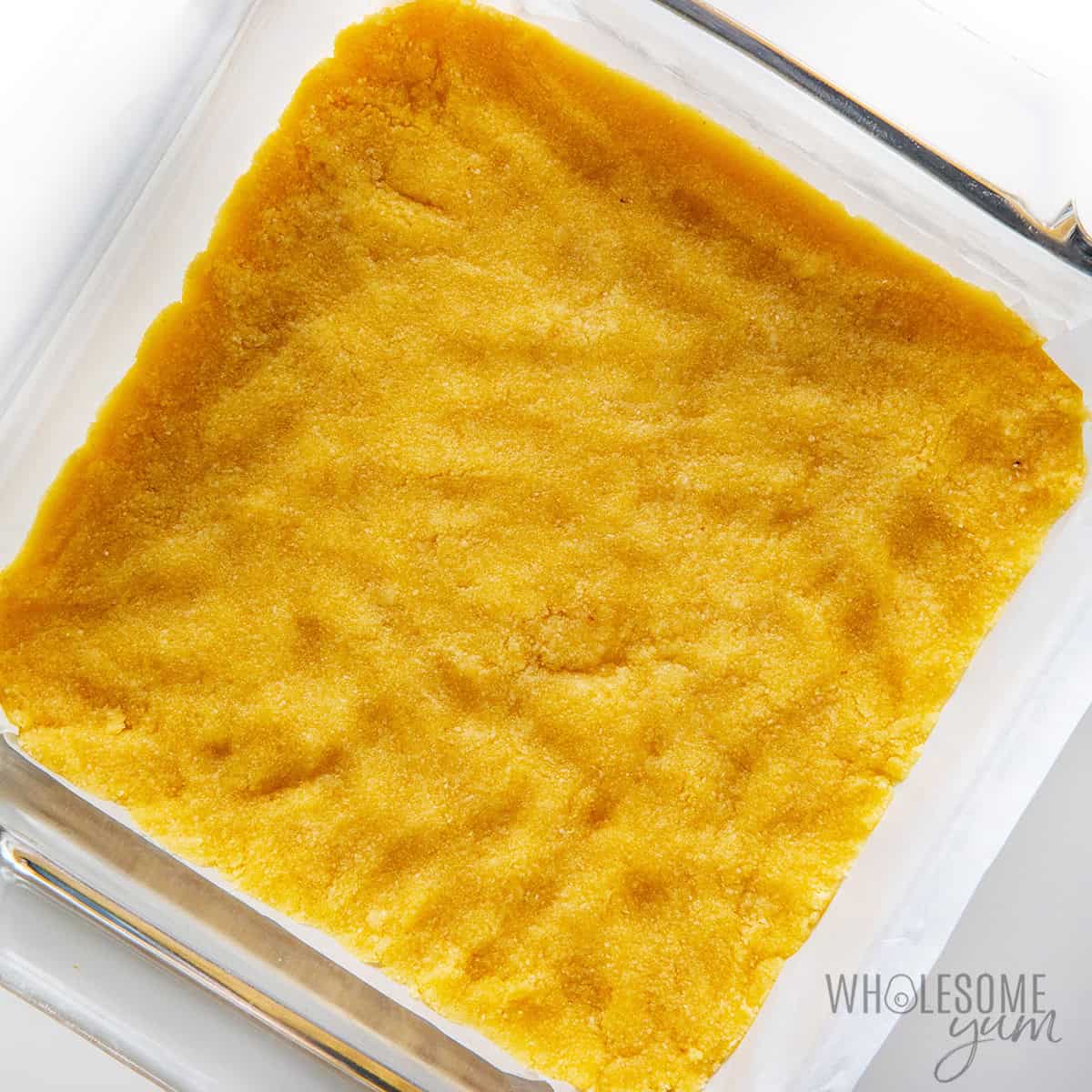 Crust pressed into the bottom of a square baking dish.
