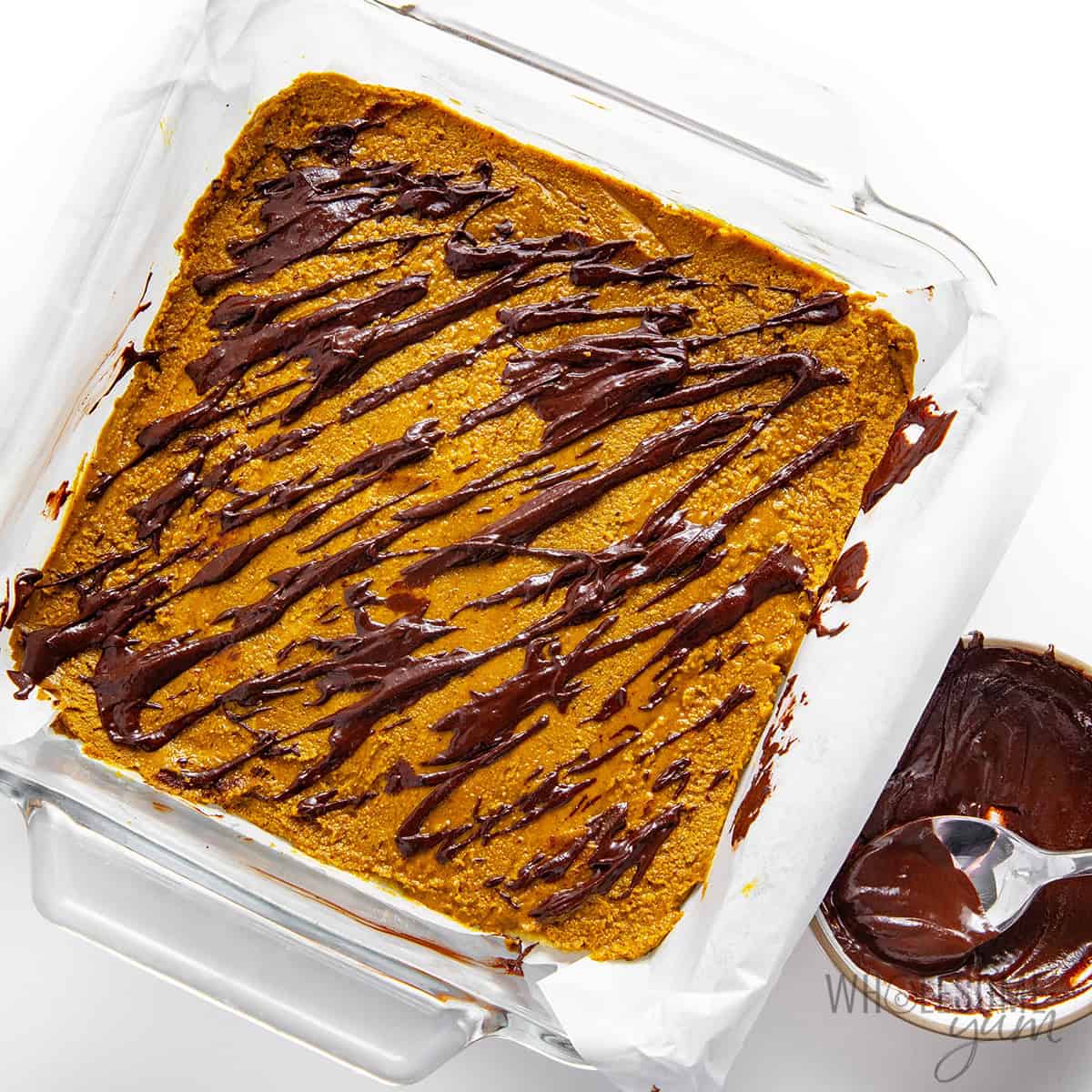 Chocolate drizzled over pistachio filling.