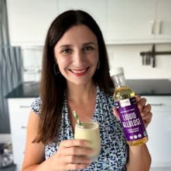 Maya holding avocado smoothie and liquid allulose.
