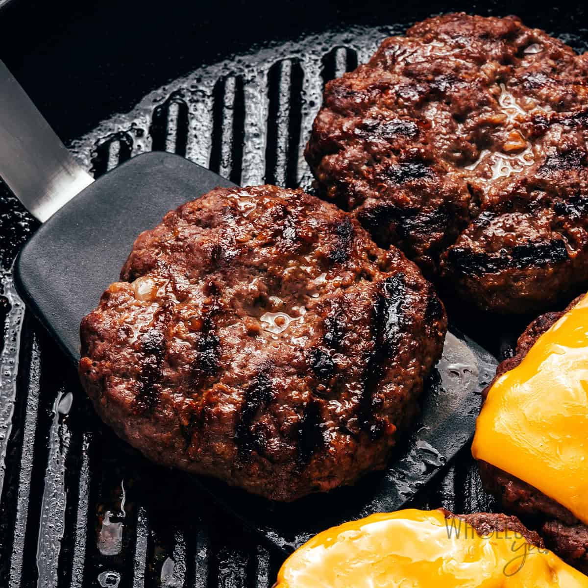 Cooking the bison burgers in a grill pan.