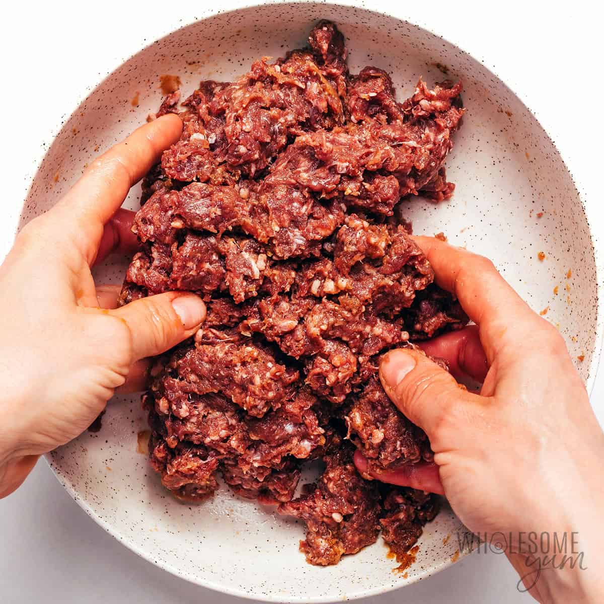 Mixing all the ingredients with the meat.