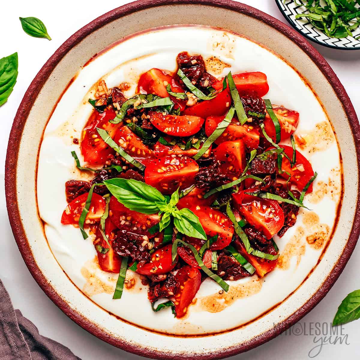 Finished bruschetta dip recipe garnished with extra basil.