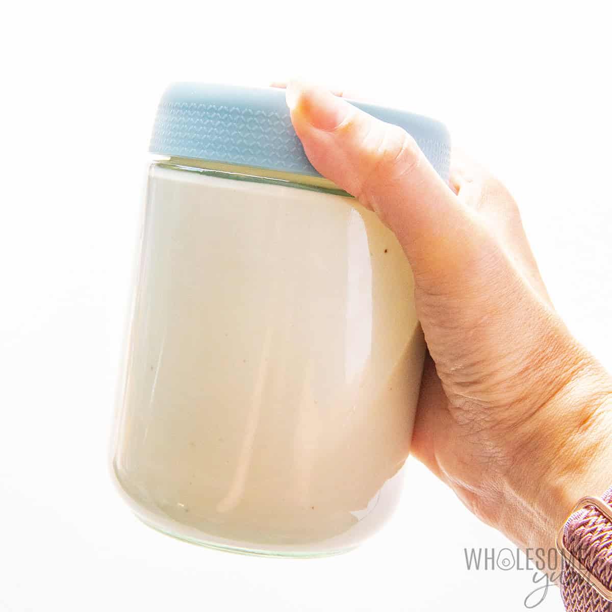 Shaking the cottage cheese ice cream base in a glass jar.