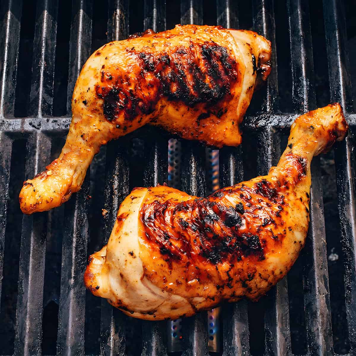 Chicken quarters on the grill.