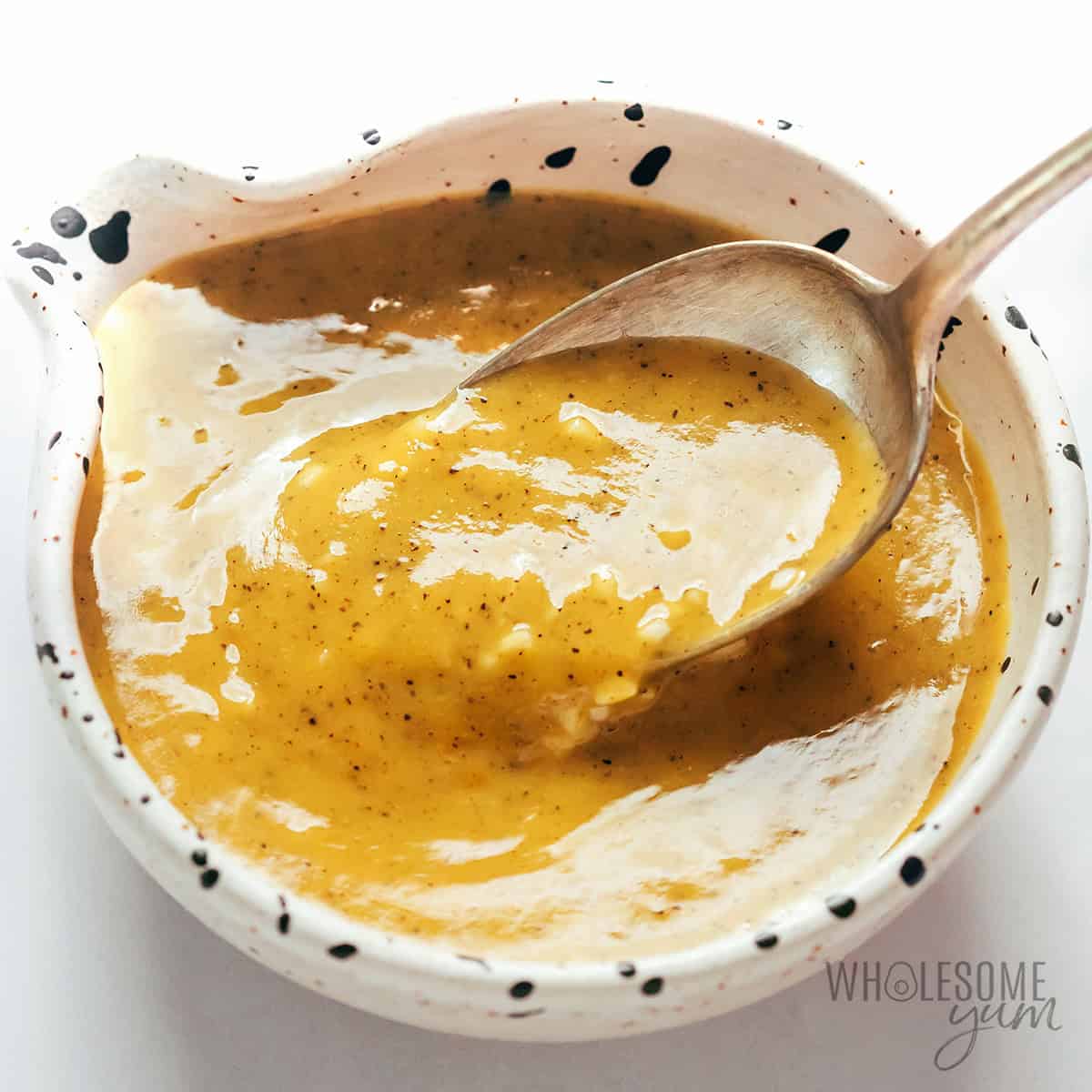 Marinade mixed in a bowl with a spoon.