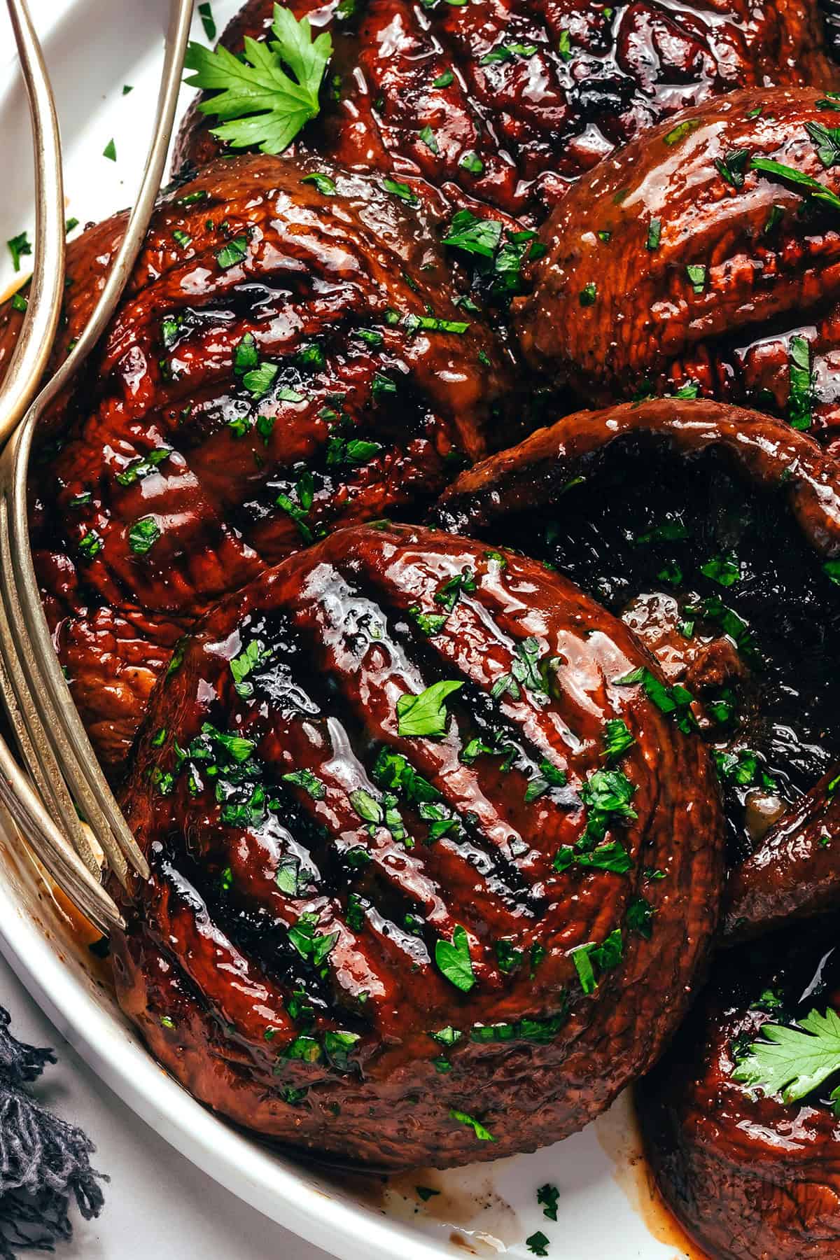 Juicy, tender grilled portobello mushrooms garnished with fresh parsley.