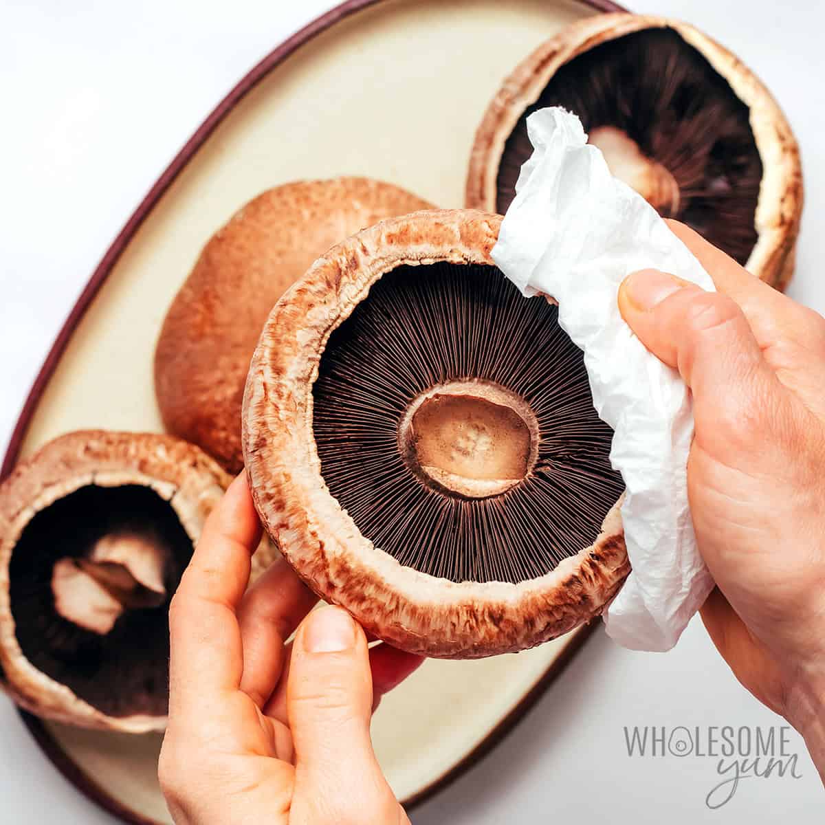 Preparing the portobello mushroom caps.