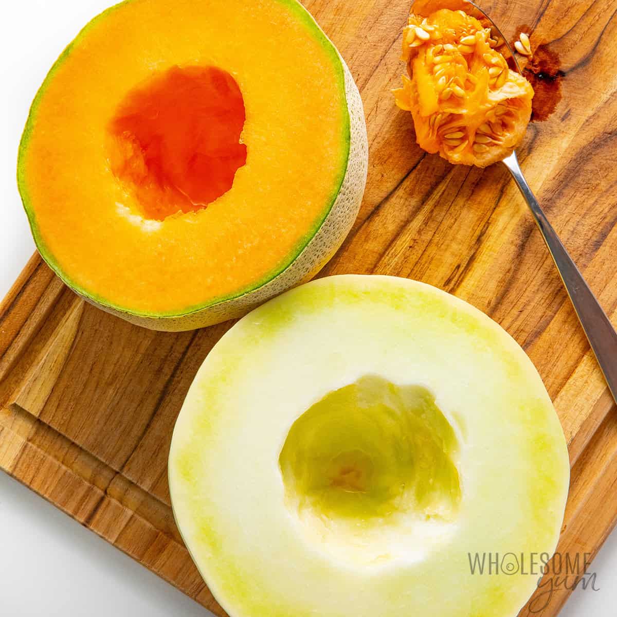 Cantaloupe and honeydew melons cut in half with the seeds scooped out.