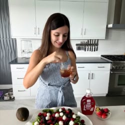 Maya mixing homemade strawberry vinaigrette for a summer berry salad.