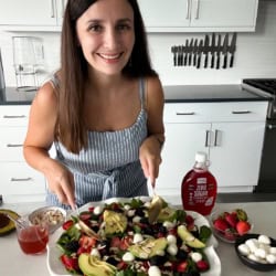 Me behind a large platter of summer salad.