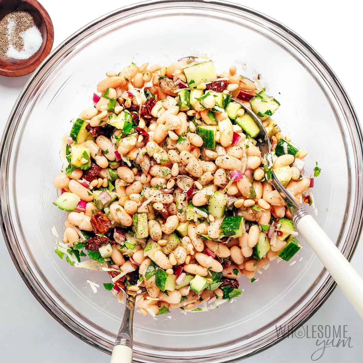 Cannellini bean salad ingredients combined in a bowl.