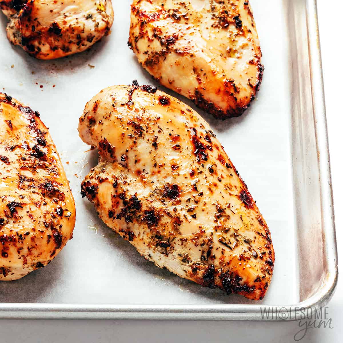 Baked yogurt marinated chicken on a sheet pan.