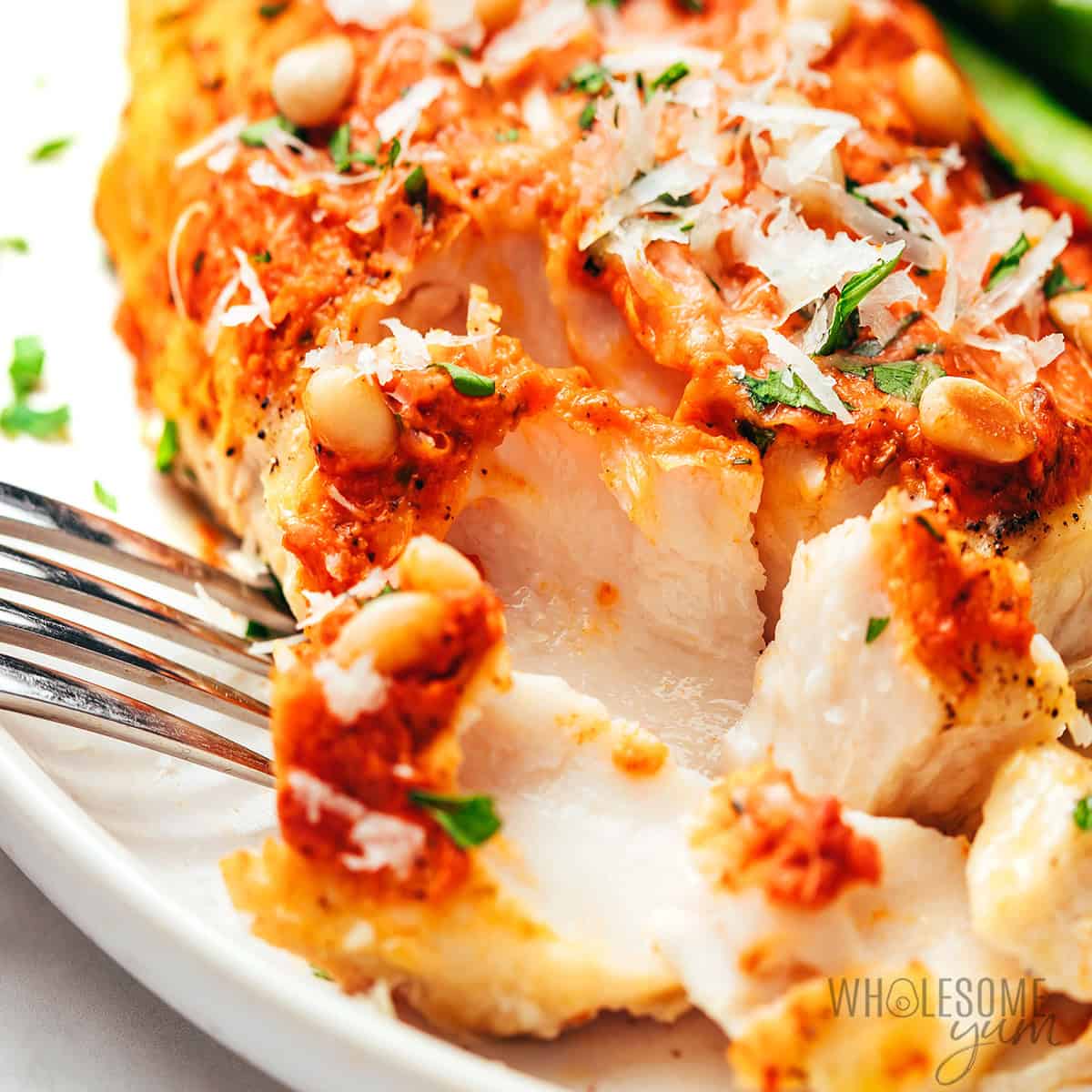Baked grouper flaked with a fork.
