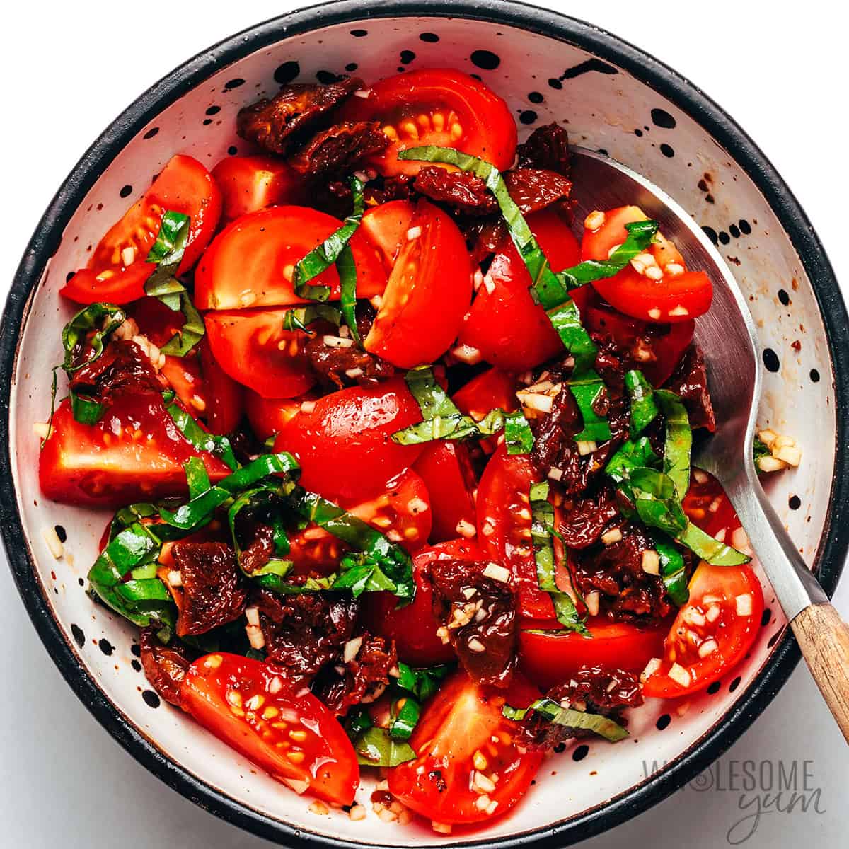 Cherry tomatoes, sun-dried tomatoes, basil, garlic, balsamic vinegar, and olive oil mixed for bruschetta topping.