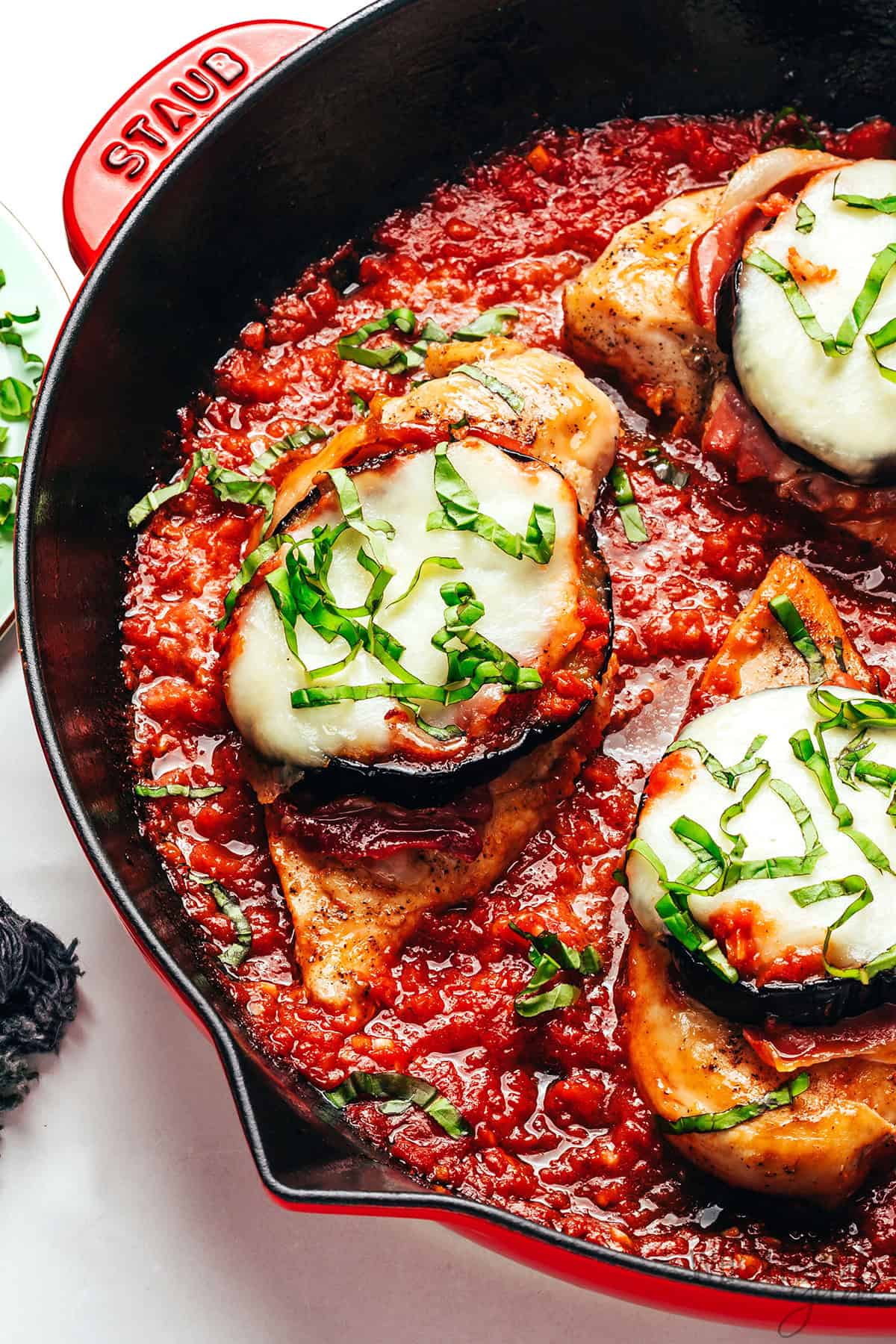 Juicy, saucy chicken Sorrentino in a skillet topped with tender eggplant, melty mozzarella, and fresh basil.