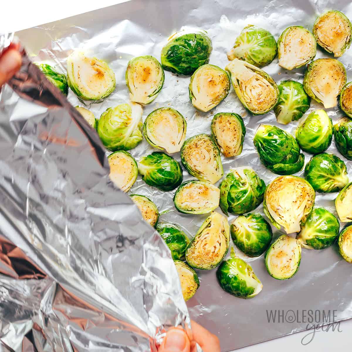 Brussels sprouts being wrapped in foil.