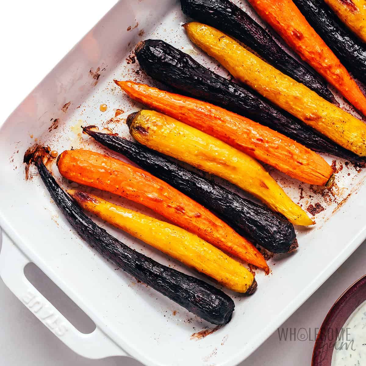 Roasted rainbow carrots in a baking dish.