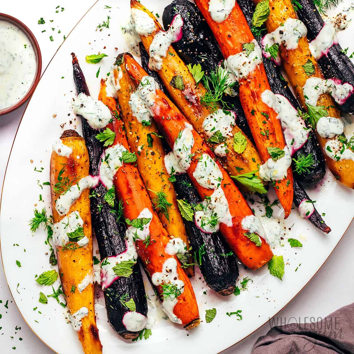 Rainbow carrots with yogurt herb sauce and fresh herbs.