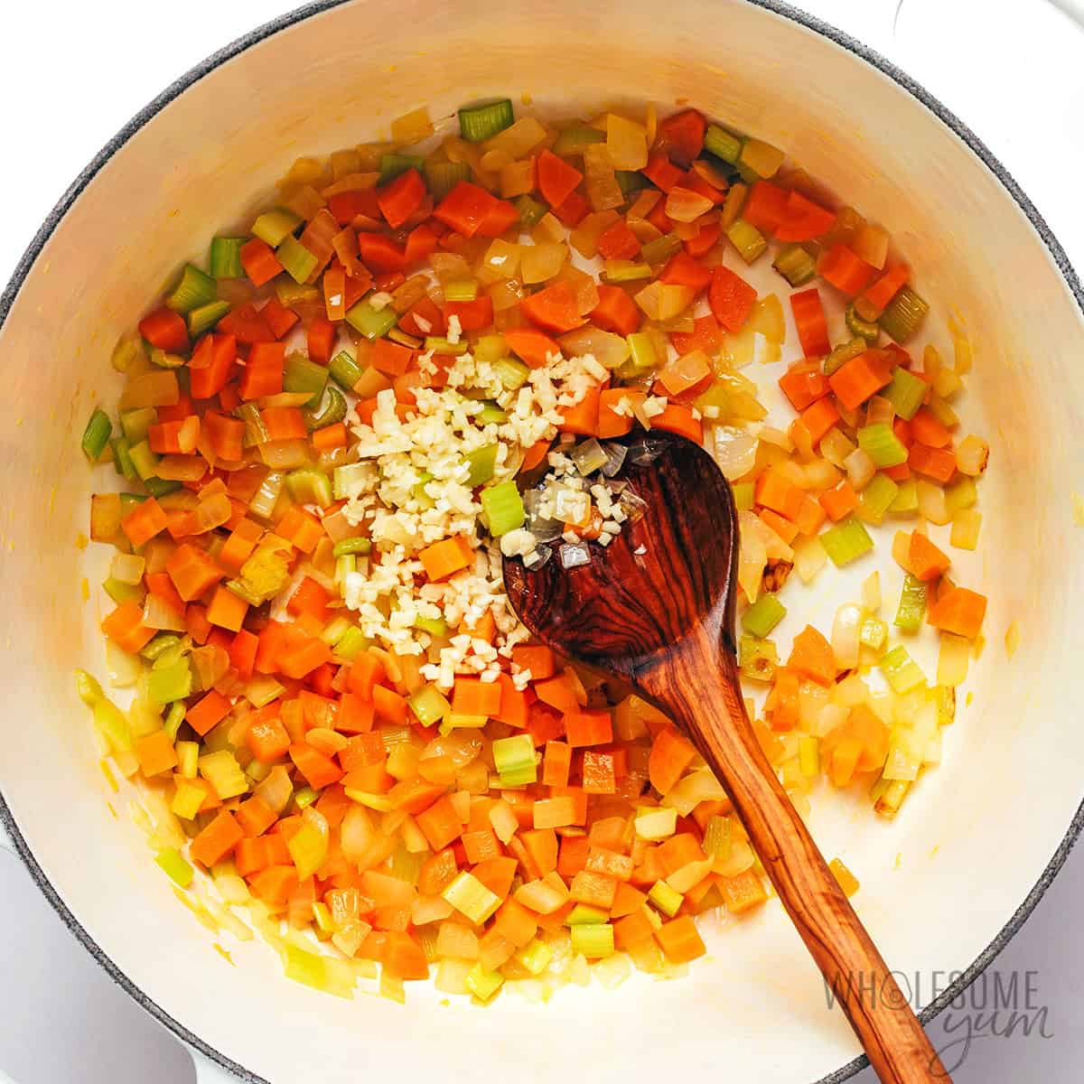Sauteed onions, carrots, celery, and garlic in a pot.