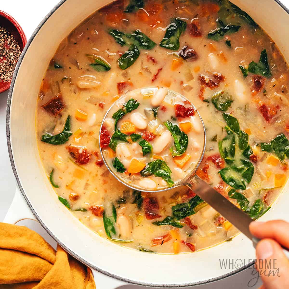 Finished white bean soup recipe in a Dutch oven.