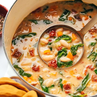White bean soup in a pot with a ladle.