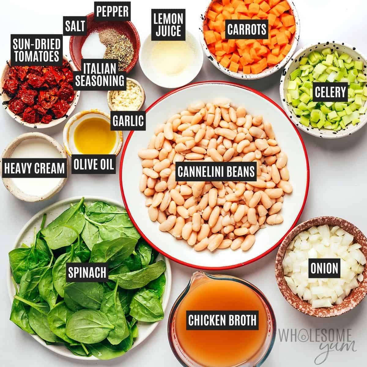 Labeled white bean soup ingredients: olive oil, onion, carrots, celery, garlic, cannellini beans, chicken broth, sun-dried tomatoes, Italian seasoning, spinach, cream, lemon juice, salt, and pepper.