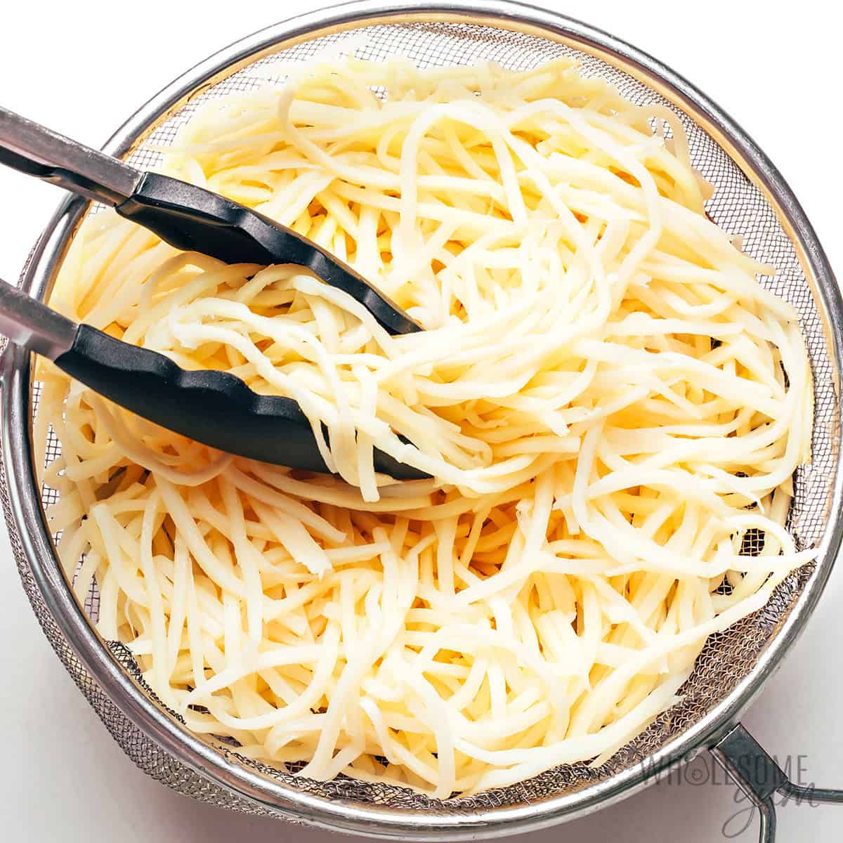 Draining the noodles.