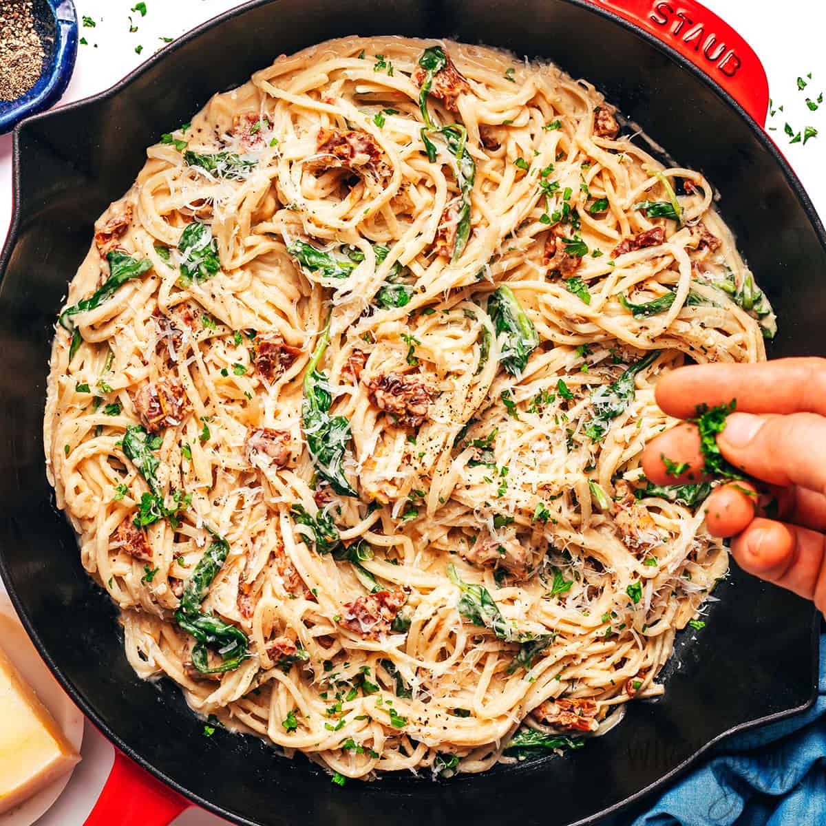 Hearts of palm pasta in a skillet and garnished with fresh parmesan cheese.
