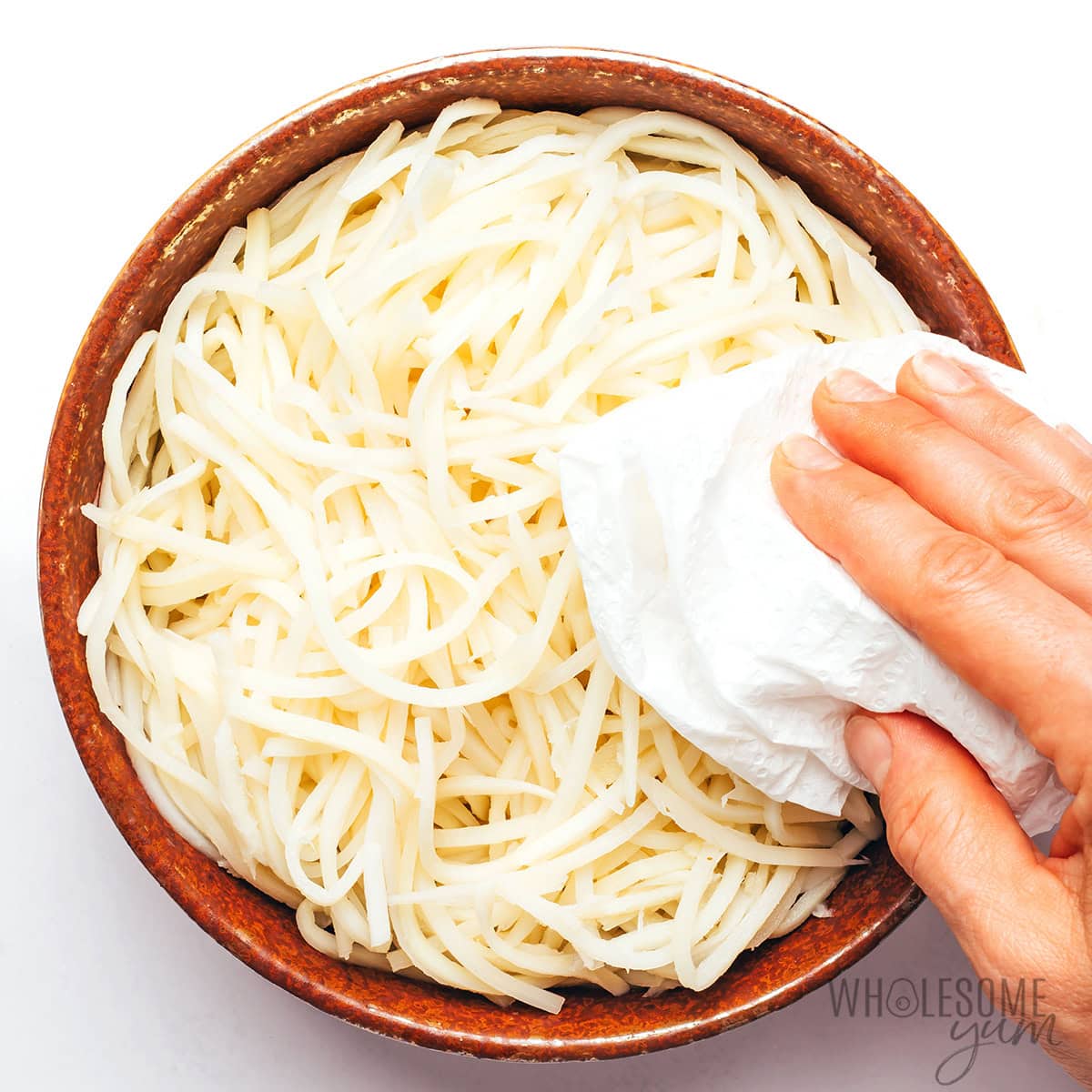 Patting the noodles dry.