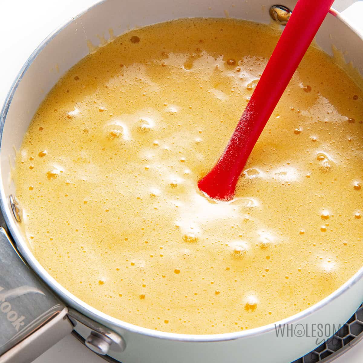 Foamed honey mixture in the saucepan after adding baking soda.