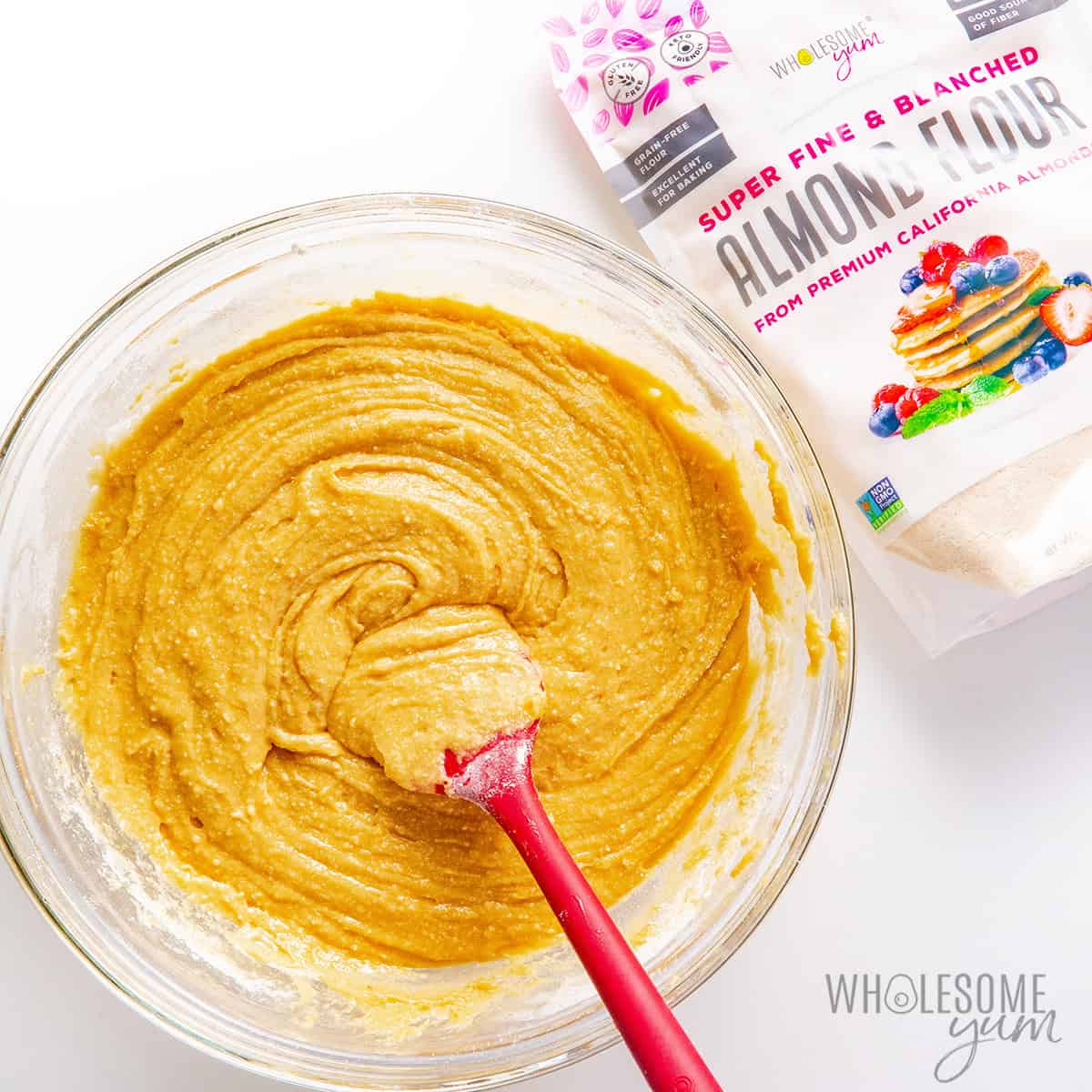 Thick honey cake dough mixed in a bowl with a spatula.
