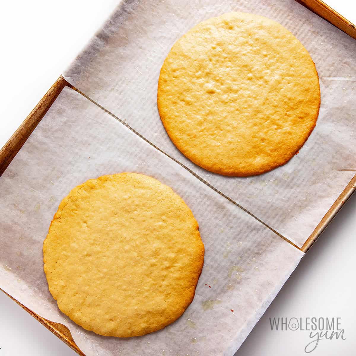 Baked honey cake layers on a pan.