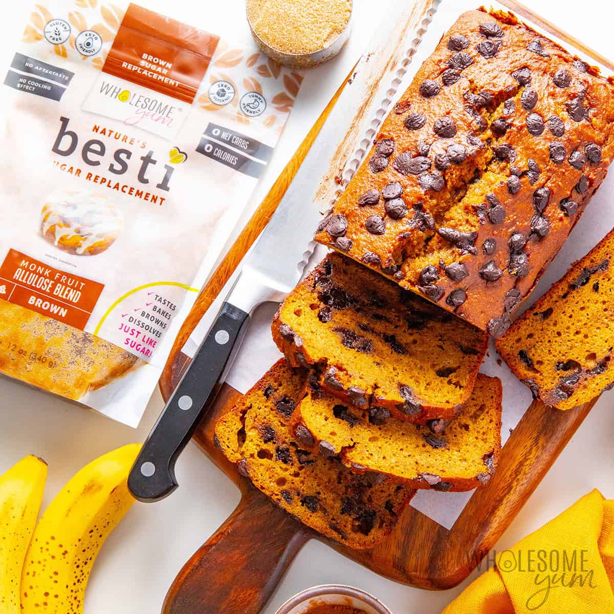 Slicing pumpkin banana bread after cooling.