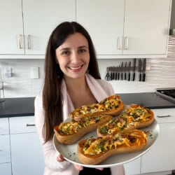 Maya with platter of stuffed butternut squash.