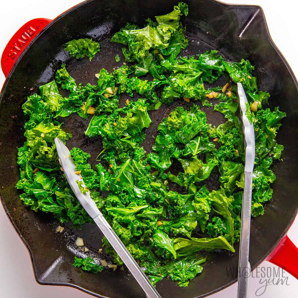 Wilted kale in a skillet.