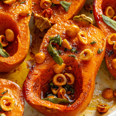 Honeynut squash close up in a baking dish.