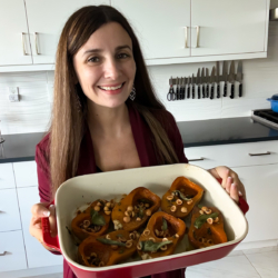 Maya with roasted honeynut squash in a baking dish.