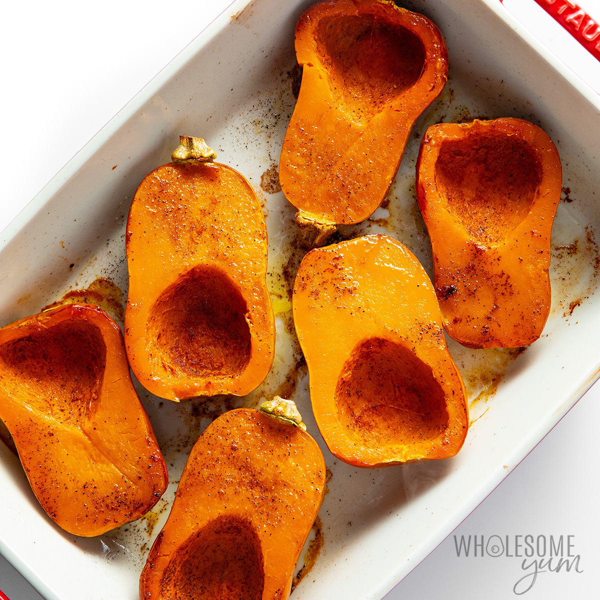 Roasted honeynut squash halves with golden edges.
